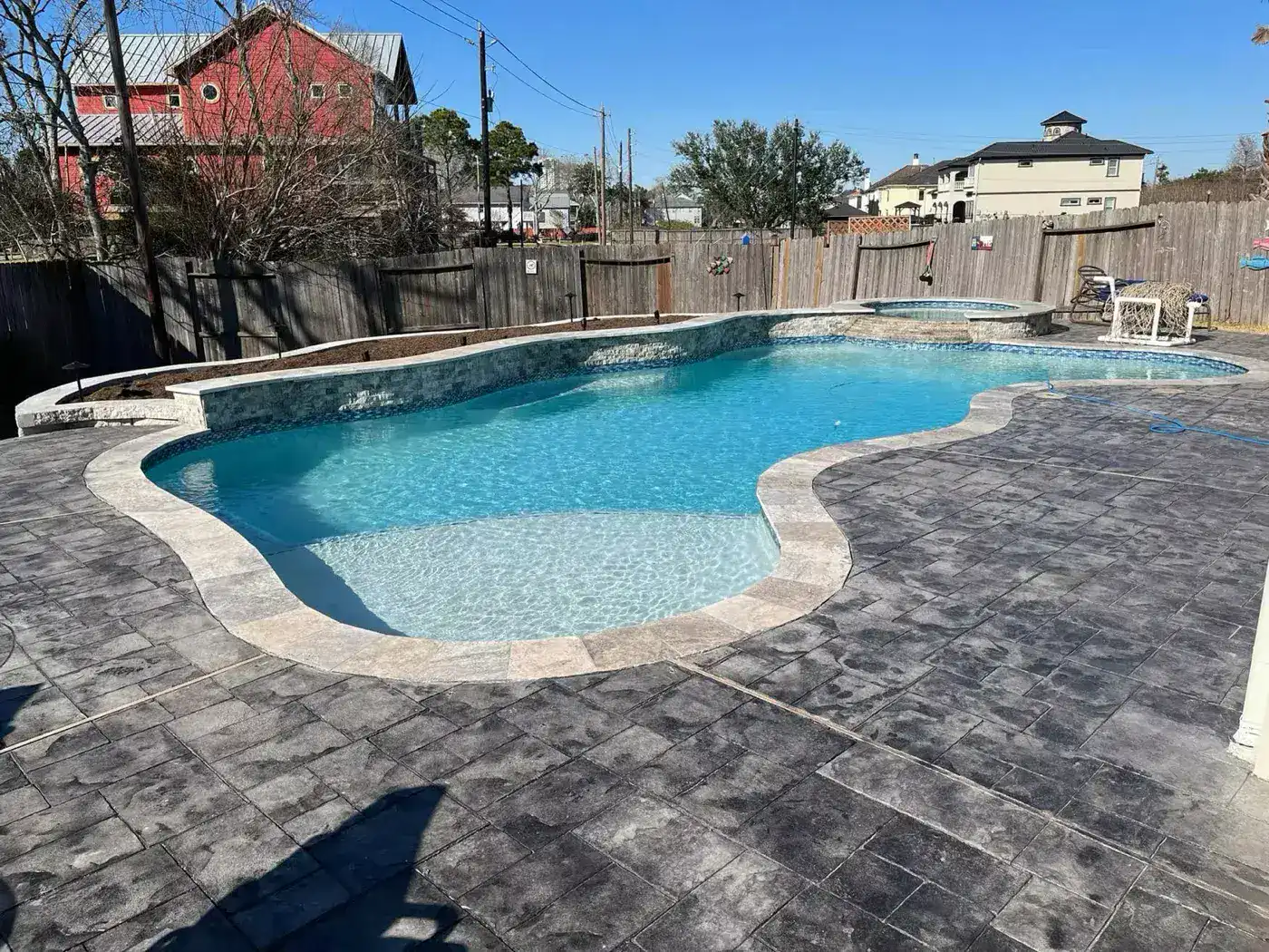 Freeform pool with stamped concrete deck