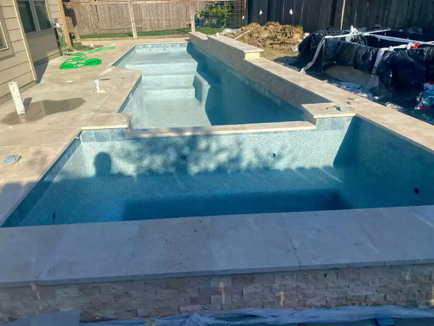 L-shaped pool with water feature