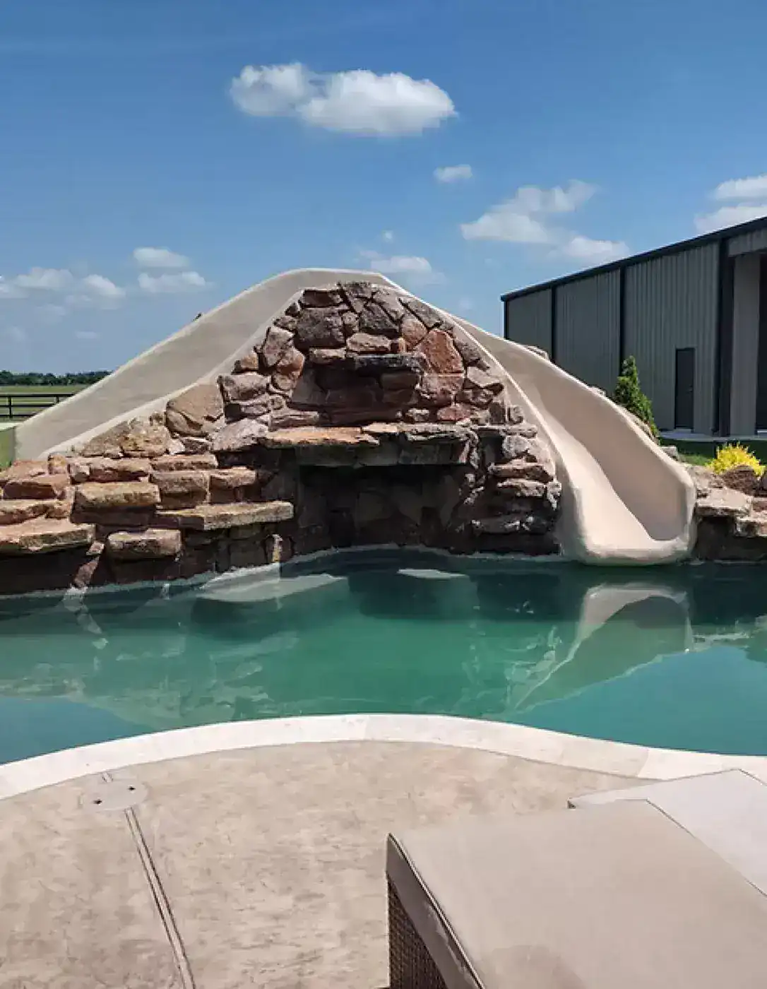 Pool with rock grotto and slide