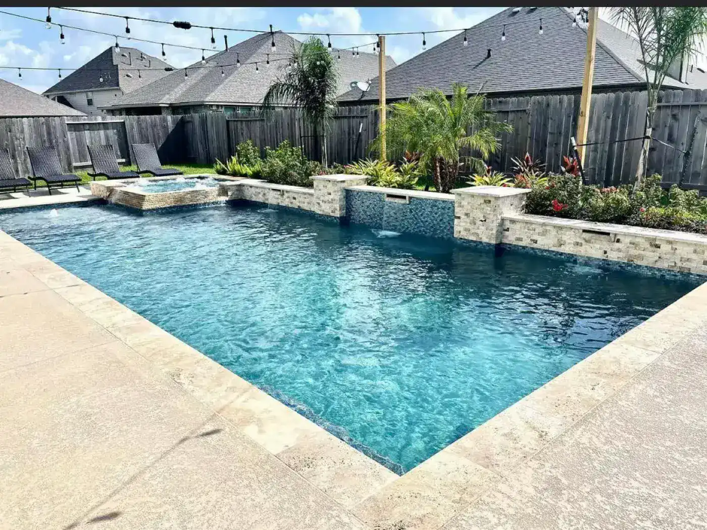 Pool with spa and string lights